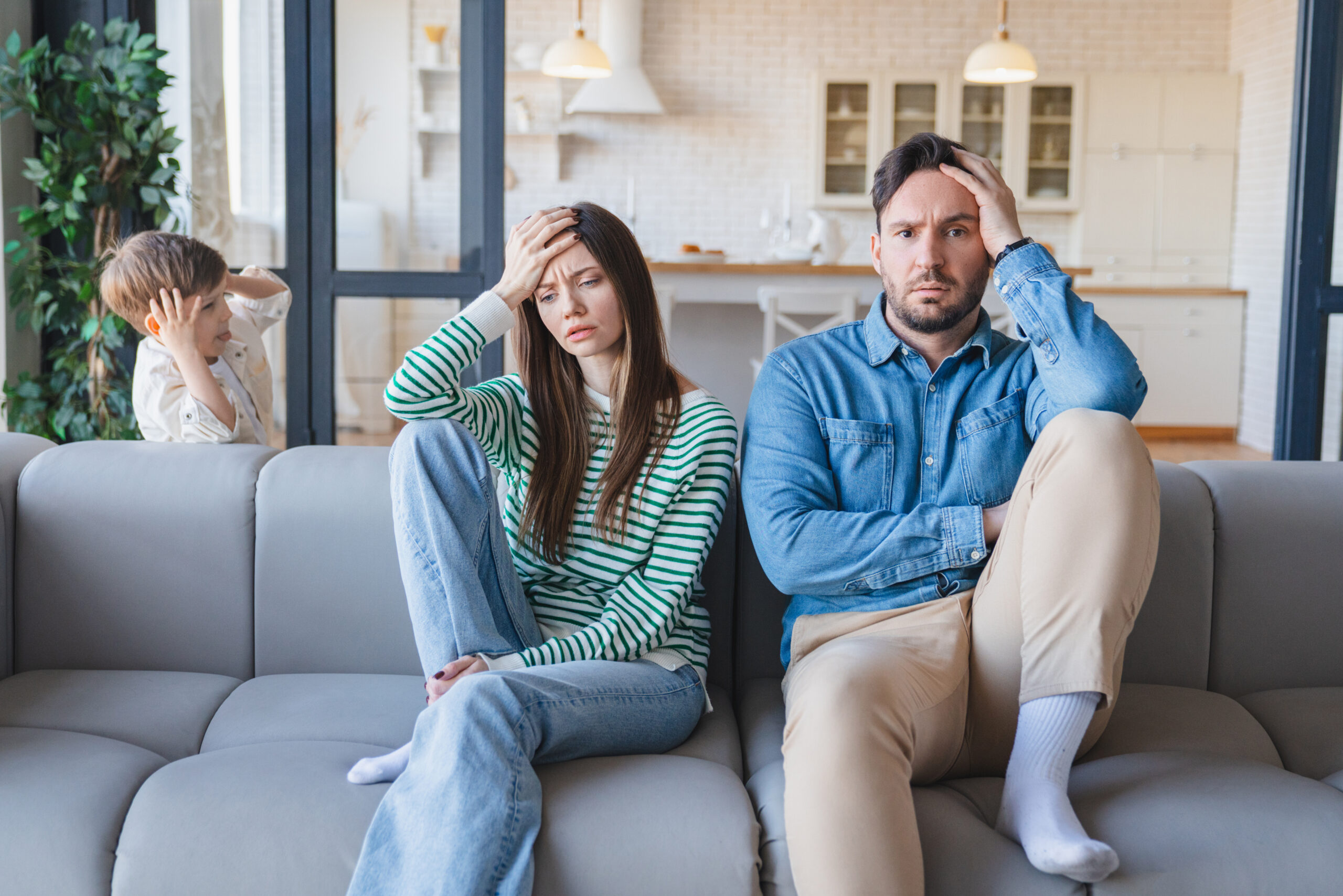 Headache, parents and child by sofa with adhd, running and impulsive behavior with motion at home.